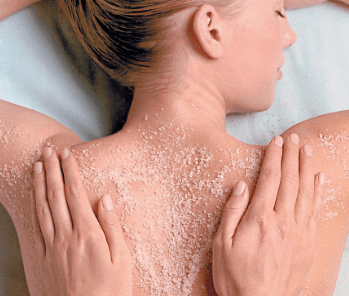 Therapist applying Lemongrass and Green Tea scrub during body scrub for oily skin in Thane at White N Bright Spa